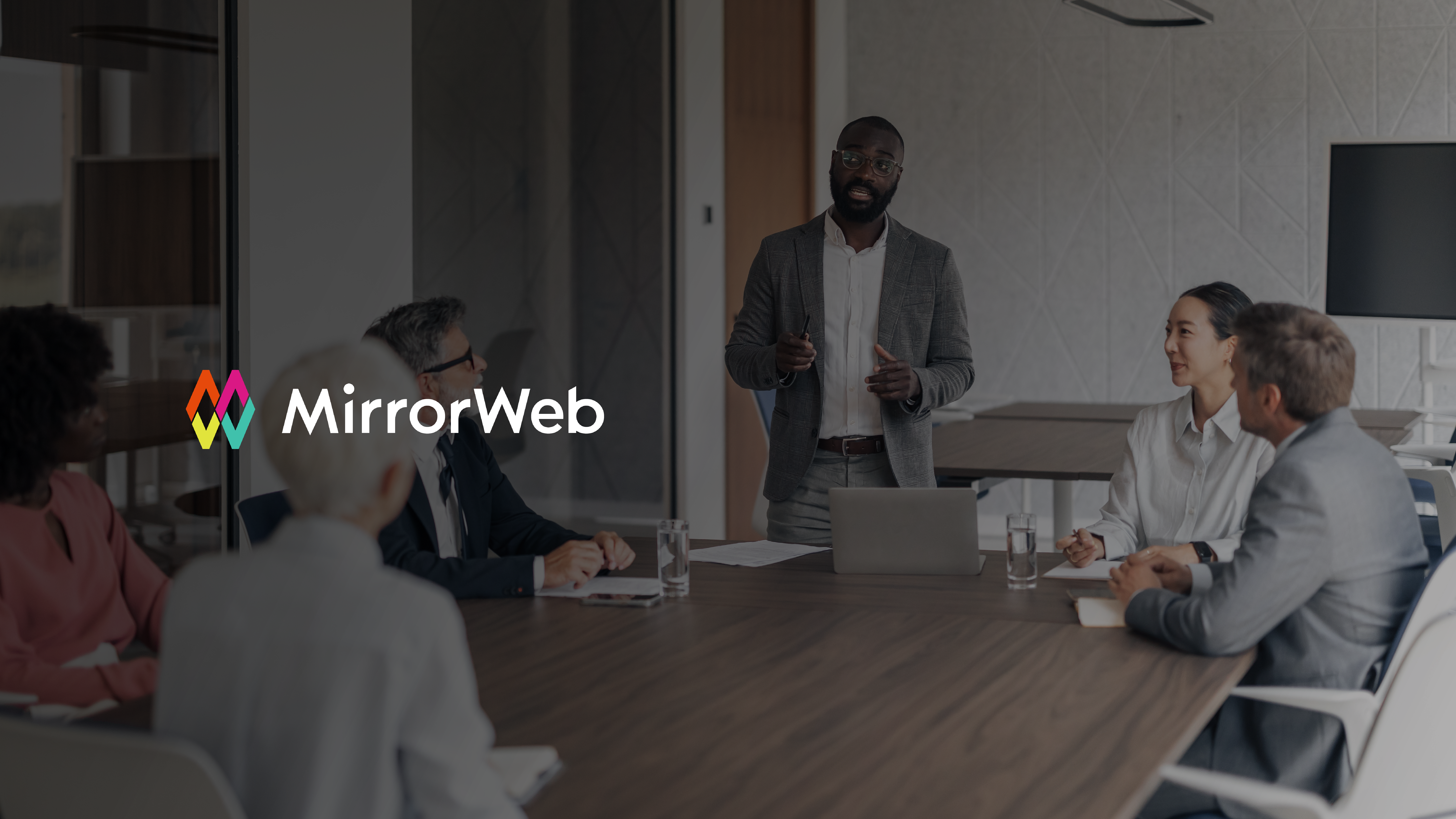 A compliance technology leader presents the business case for RegTech investment to a group of financial services executives in a modern boardroom.