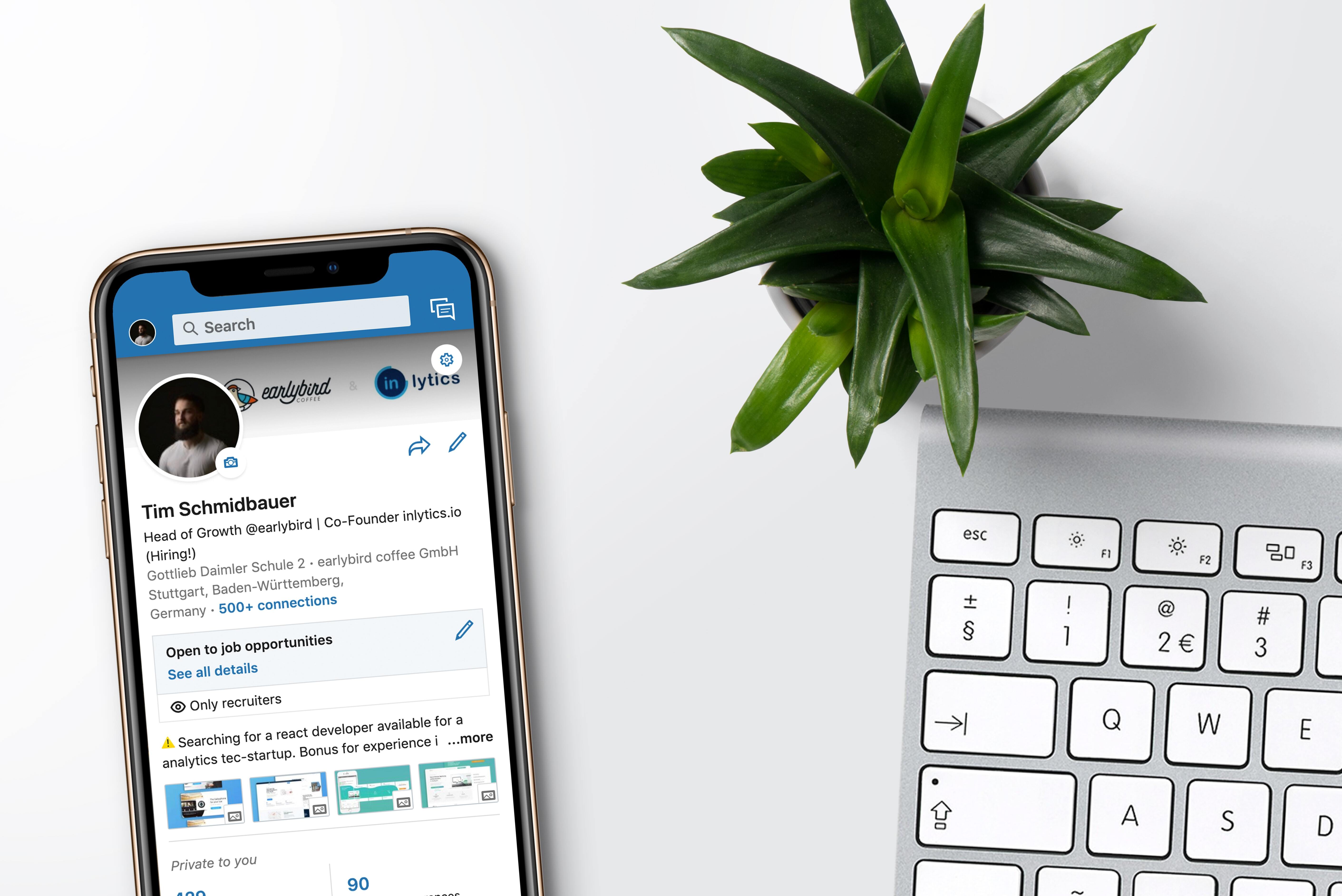 LinkedIn profile on smartphone next to keyboard