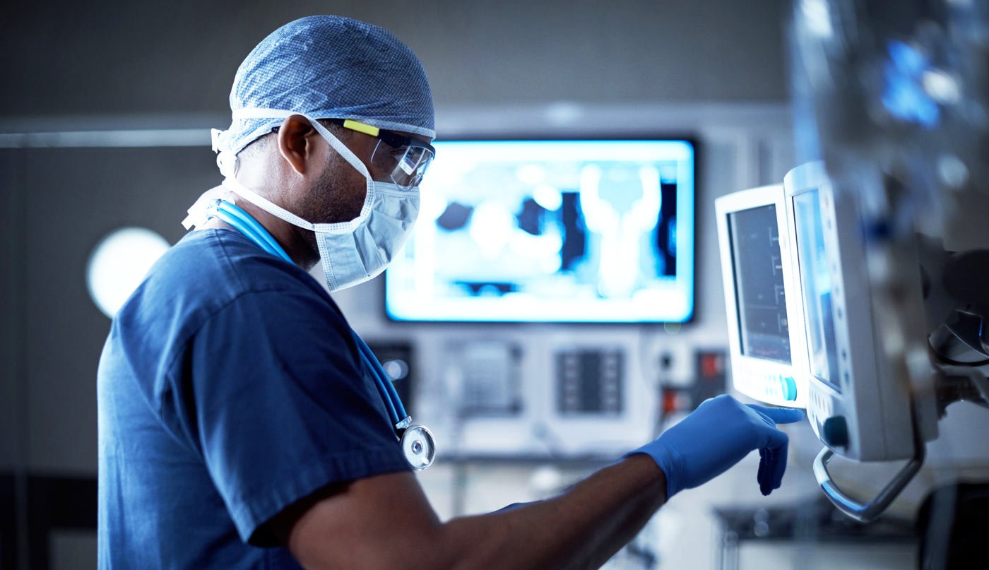Vigilantly monitoring his patient's vitals stock photo