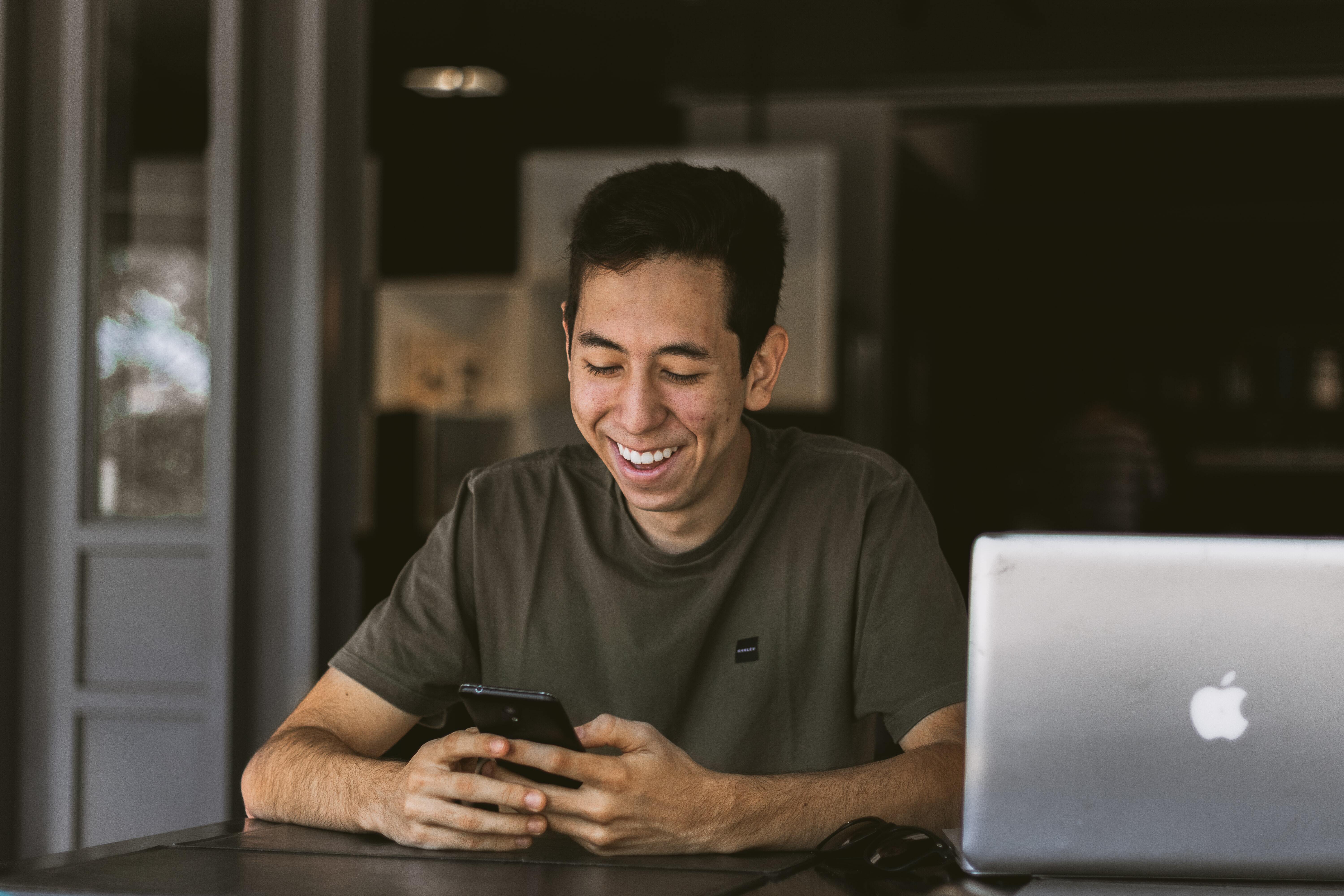 man smiling on smartphone