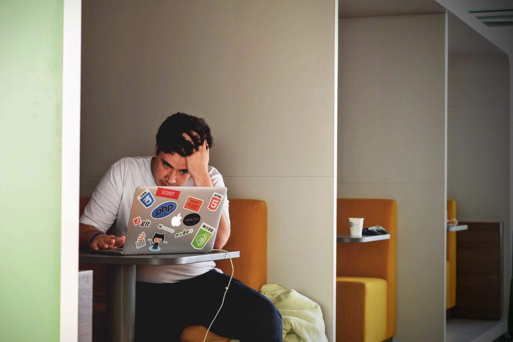 Man stressed on laptop