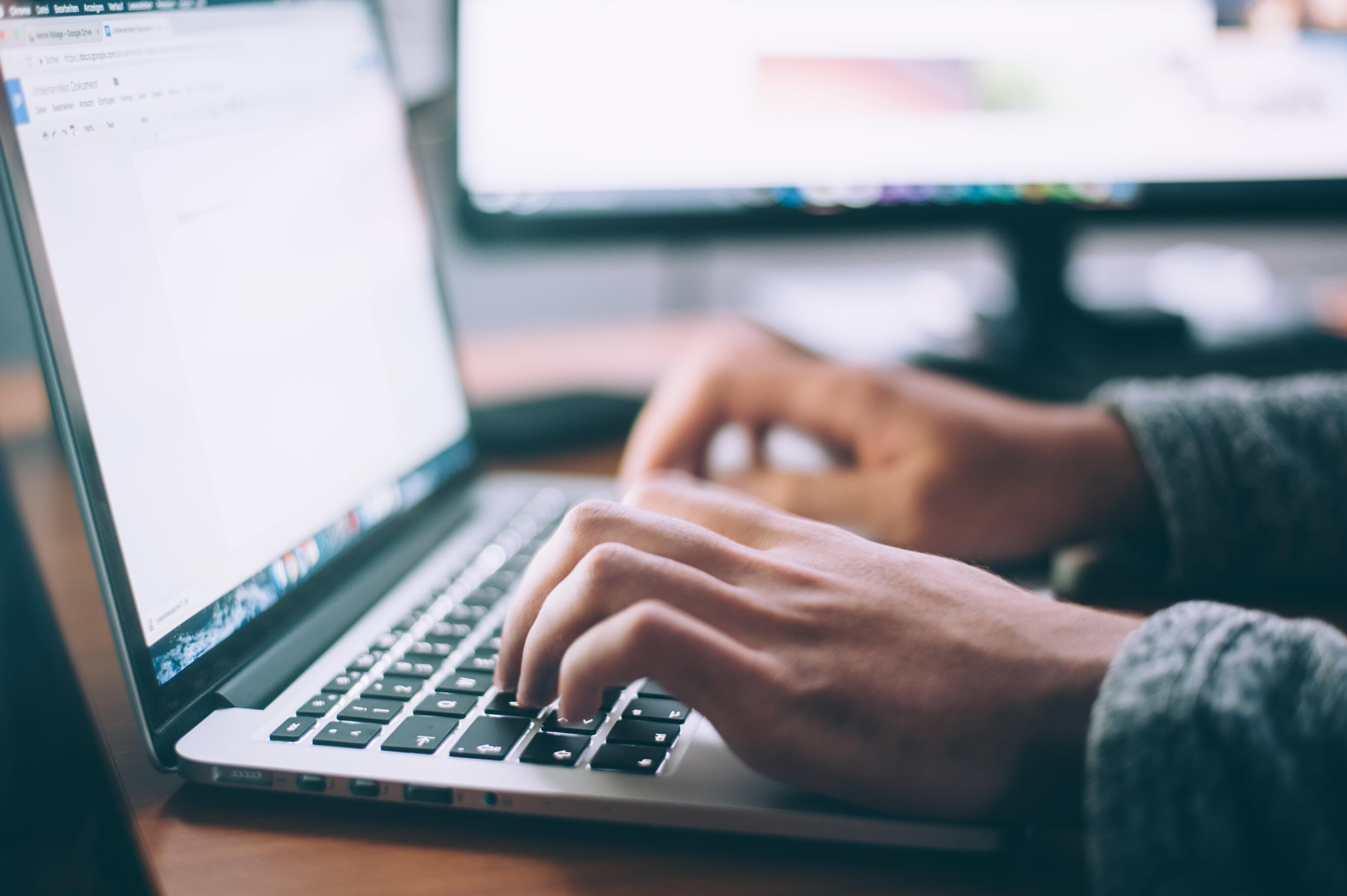 Person typing on a laptop while working from home